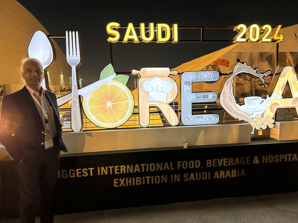 Man in front of an exhibition stand.